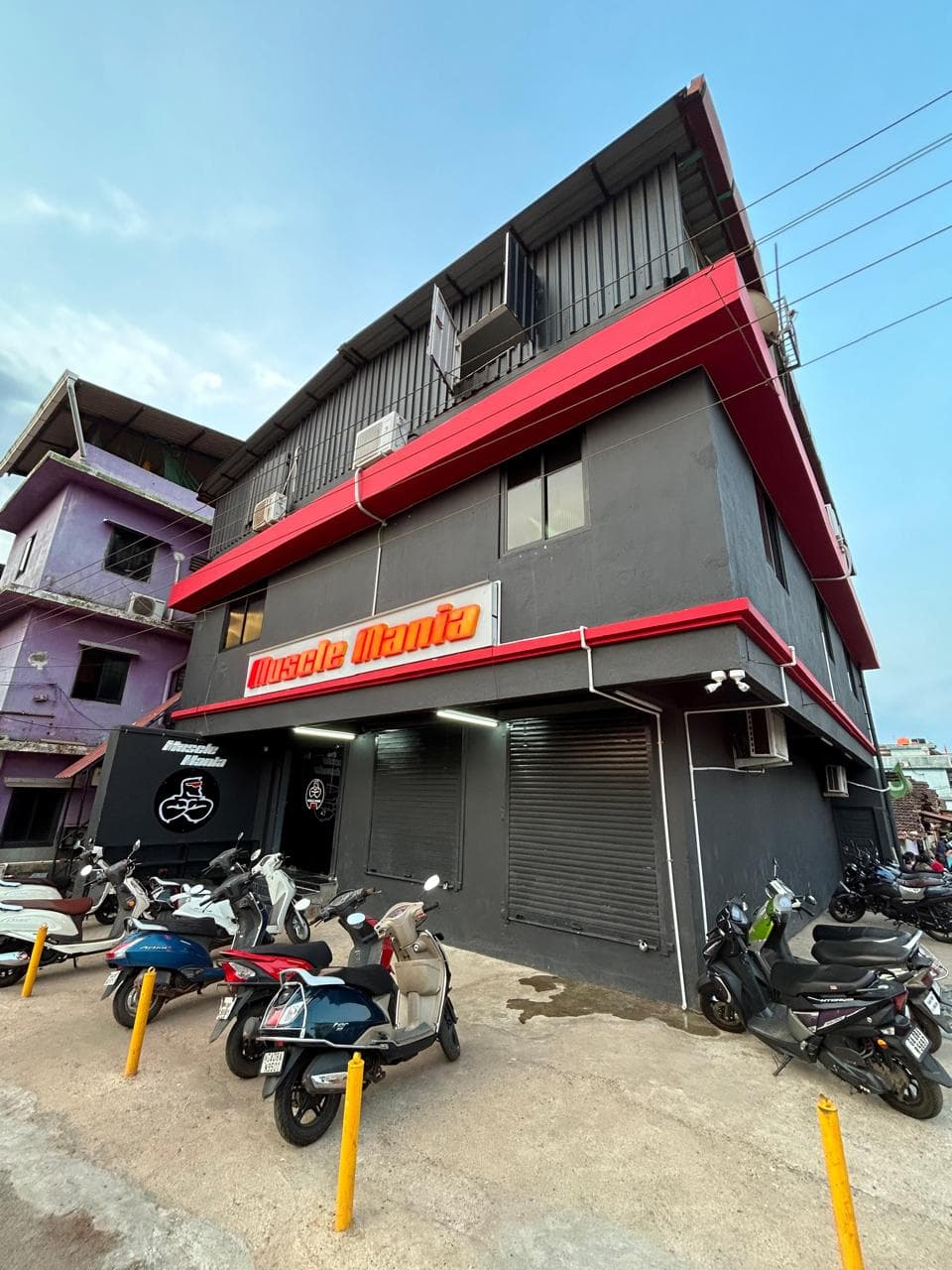 The Muscle Mania gym building with its red and black exterior